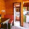 Interno di legno, tavolo verde, cucina verde e bianca.