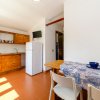 Cucina con mobili in legno e tavolo apparecchiato.