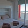 Camera con letto matrimoniale, asciugamani piegati e vista mare dalla finestra.